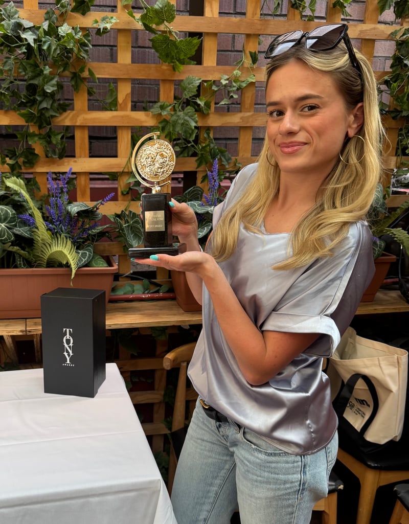 OTS team member Annika holding a Tony Award